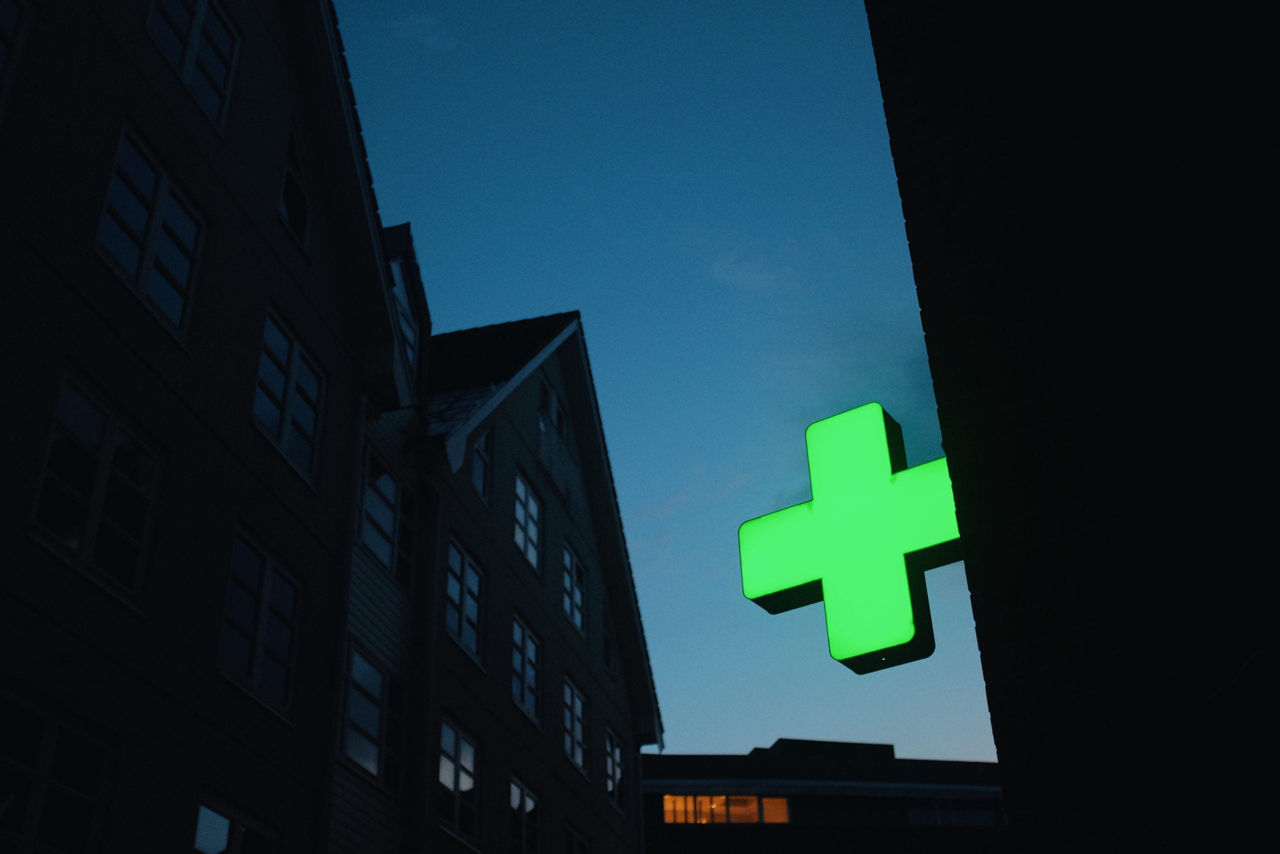green neon cross pharmacy hospital sign on a buil 2021 12 09 09 44 54 utc scaled